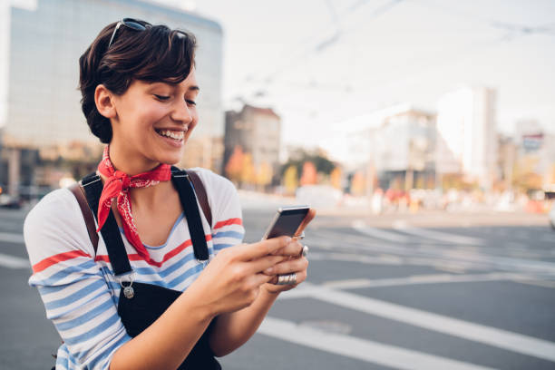 istock Beautiful young woman calling for a cab 1187887687