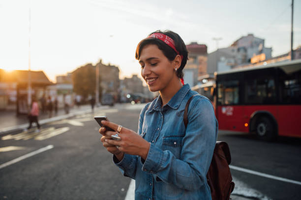 istock Beautiful young woman calling for a cab 1187887688