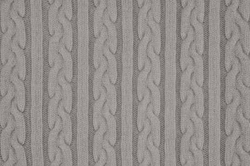 Knitwear Fabric Texture with Pigtails and stripes. Repeating Machine Knitting Texture of Sweater. Gray Knitted Background.