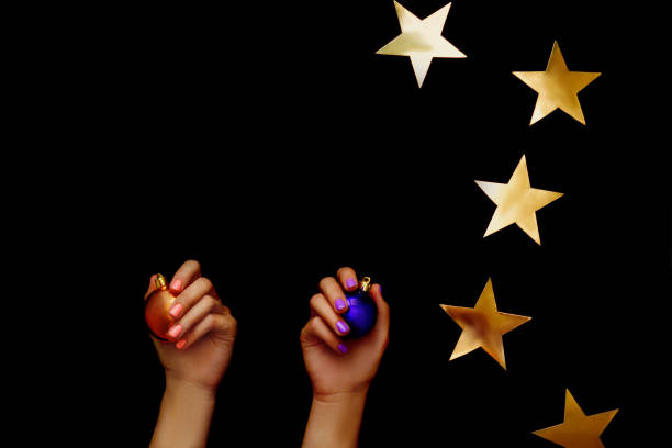 istock Christmas. Gold star and balls in hands. 1187890925