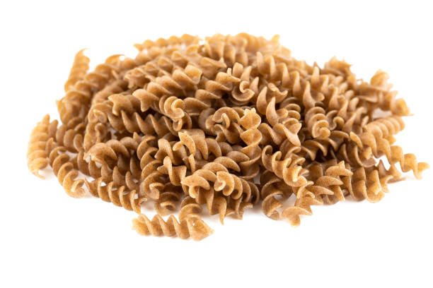 The heap of fusilli pasta The heap of fusilli pasta isolated on white background. carbohydrate food type stock pictures, royalty-free photos & images