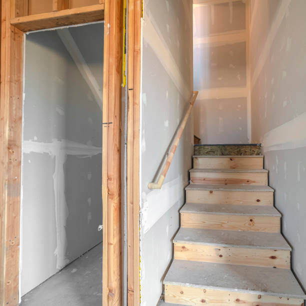 istock Square frame Under construction wooden stairs in a basement 1187891007