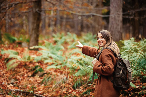 istock girl with a backpack in the autumn forest 1187891645
