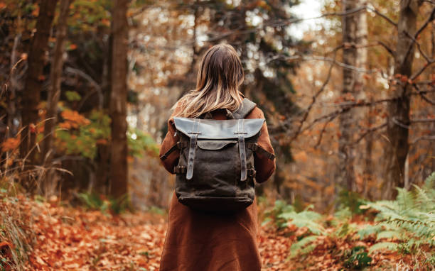 istock girl with a backpack in the autumn forest 1187891653