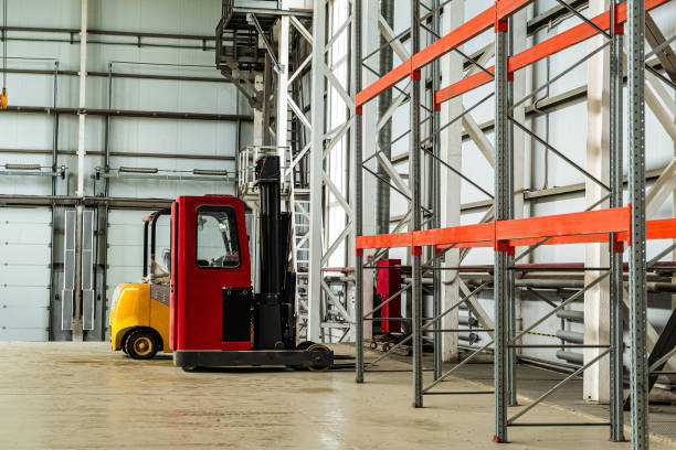 istock Forklift trucks in a industrial warehouse building 1187891852