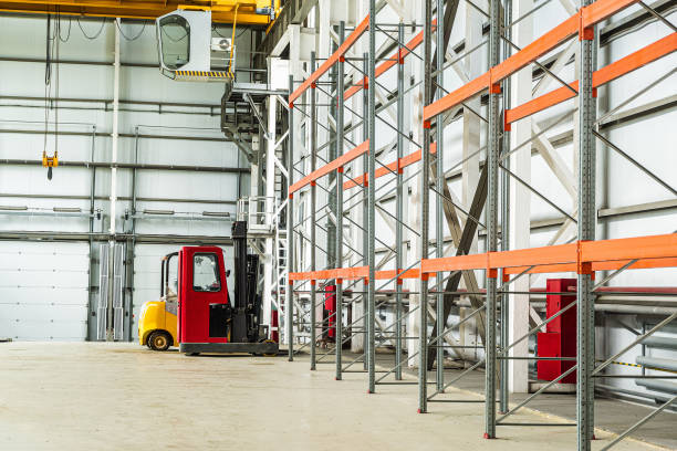 istock Forklift trucks in a industrial warehouse building 1187891855
