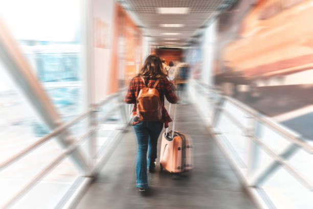 istock Tourist pulling suitcase in airport terminal 1187894898
