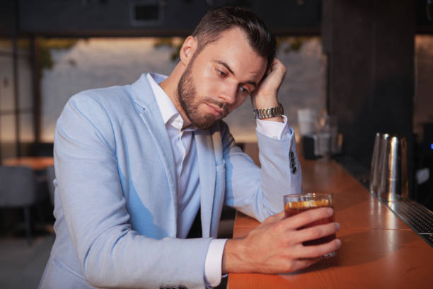 istock Handsome elegant man drinking at the bar 1187897150