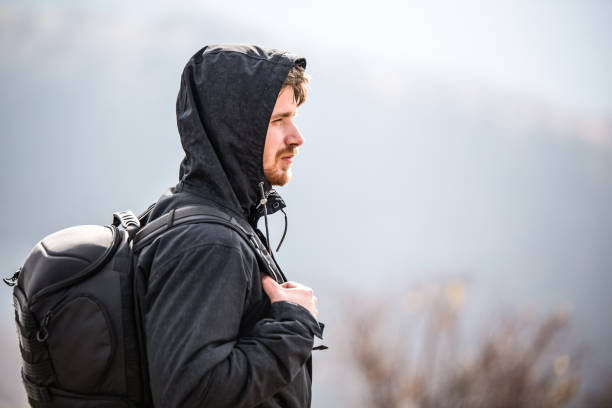istock Young man hiking on a mountain on a cold day. 1187898090