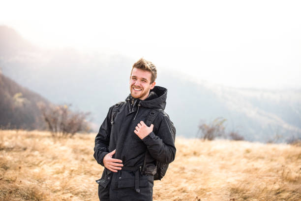 Happy young man exploring the mountain.