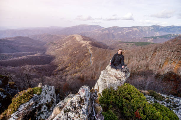 istock Young man meditating on mountain top. 1187898899