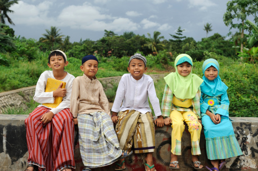 Group of Muslim kids, sitting on bridge