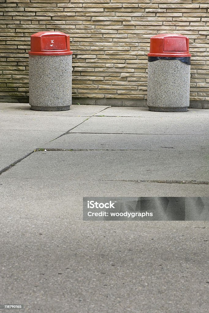 Two garbage cans against stone wall  Color Image Stock Photo