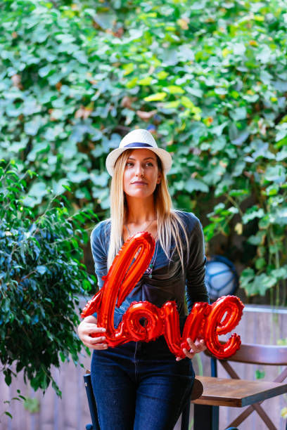 Woman Holding Love Balloon in Hand