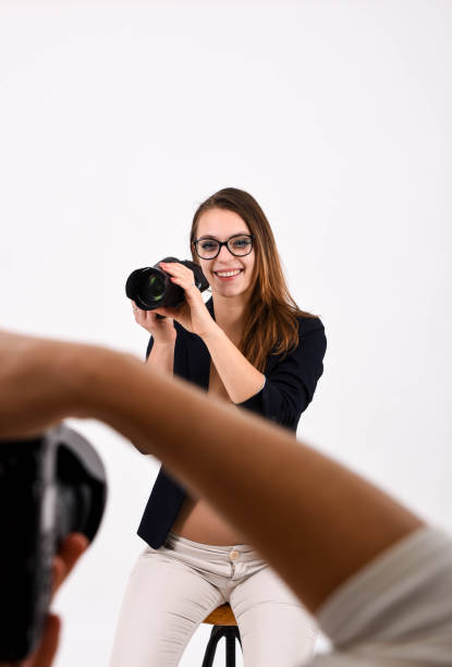 istock A young posing woman in the studio doing a commercial for a camera 1187907549