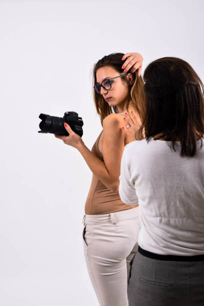 istock A young posing woman in the studio doing a commercial for a camera 1187907559