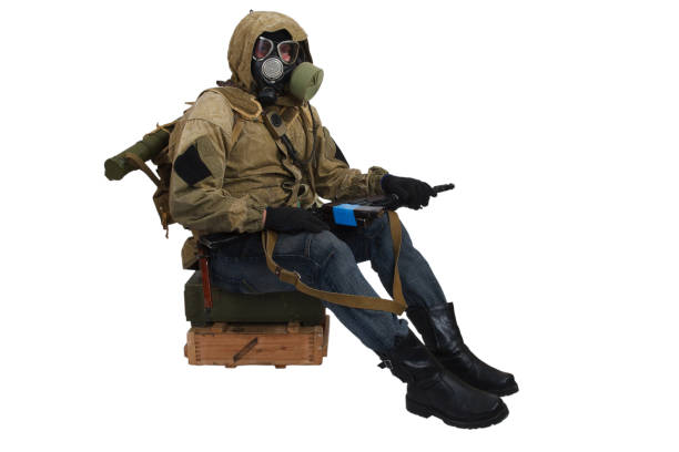 istock Stalker in gas mask with ak-47 gun isolated on white 1187908363