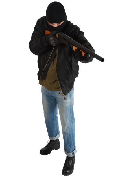 istock robber in black mask with shotgun 1187908622
