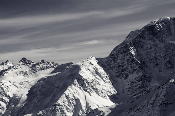 istock Black and white snowy sunlight mountains 1187911102