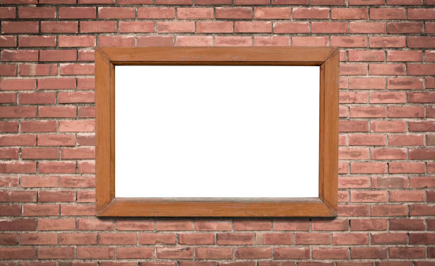 istock blank brown wooden picture frame on brick wall background 1187915358