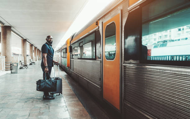 istock Afro businessman entering the train 1187916211
