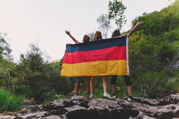 istock Three friends holding German flag 1187917916