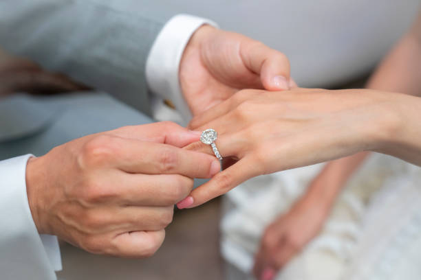 Commitment Wearing a ring at the engagement ceremony jewelry photos stock pictures, royalty-free photos & images