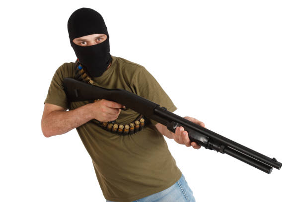istock robber in black mask with shotgun 1187920370