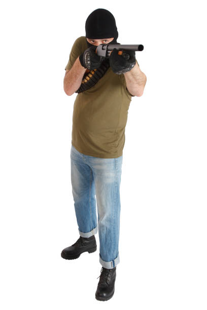 istock robber in black mask with shotgun 1187920399