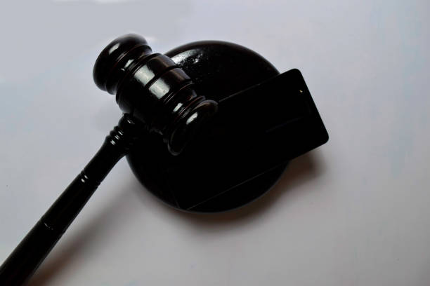 istock Black smartphone and gavel isolated on white background. Justice and Law Concept 1187920587