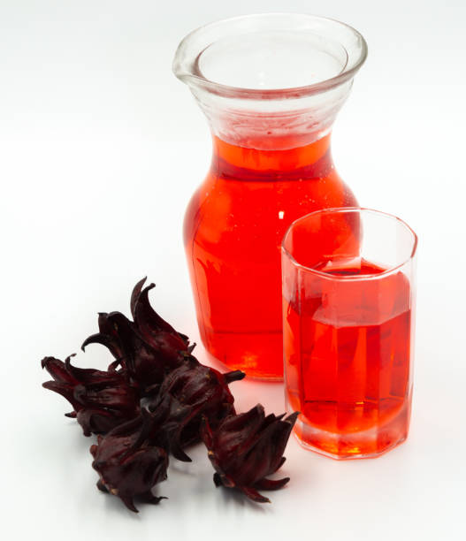 istock Roselle juice in pitcher with glass and roselle fruit on white background 1187927600