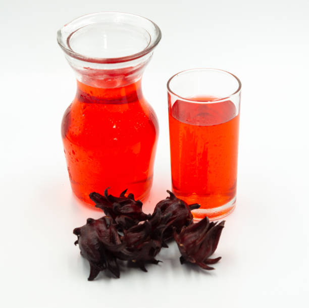 istock Roselle juice in pitcher with glass and roselle fruit on white background 1187927611