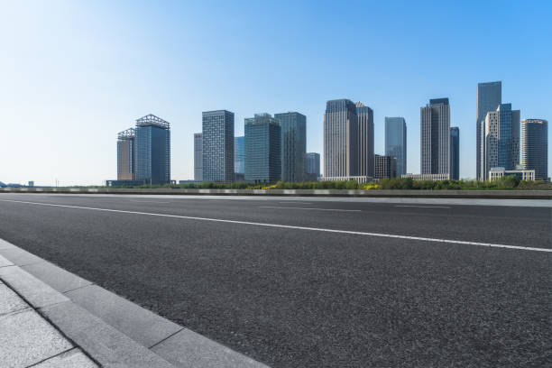 istock empty asphalt road with city skyline background in china 1187935101