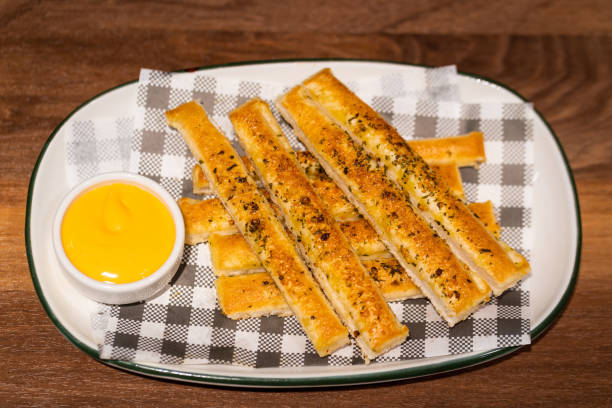 istock Bread stick with cheesy sauce - Food on the table. 1187936384
