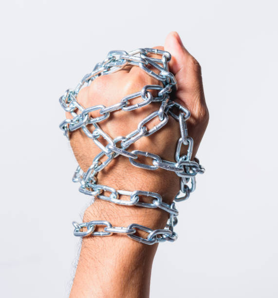 istock Chained fist hands on white background 1187937008