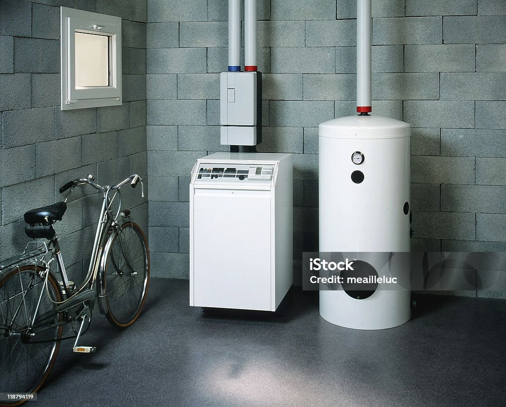 boiler room and bicycle white boiler in the basement of a house Boiler Stock Photo