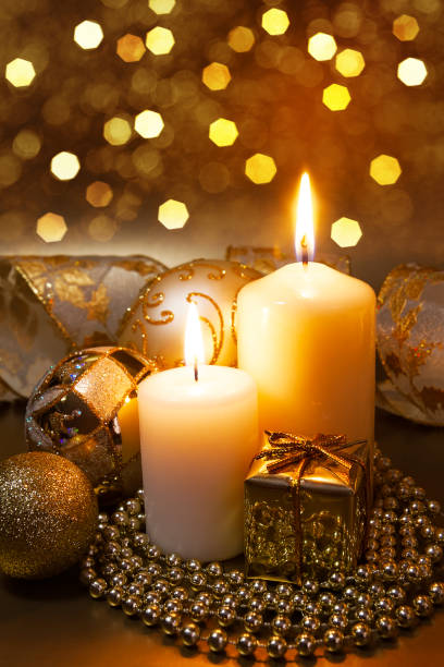 istock Christmas ornaments over dark golden background with lights. 1187945874