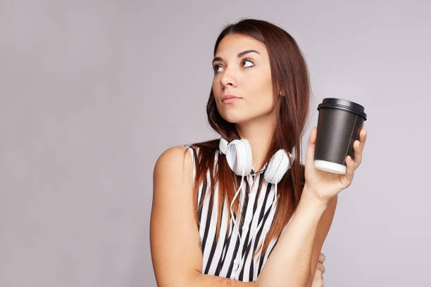istock Beautiful woman models over grey wall with copy space for your advertisement or promotion. 1187949332