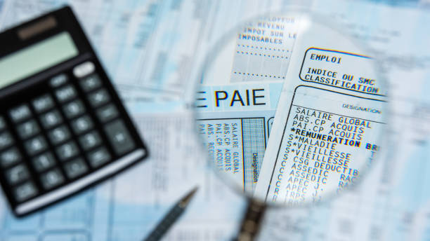 istock French payroll with a calculator and a magnifying glass 1187953085