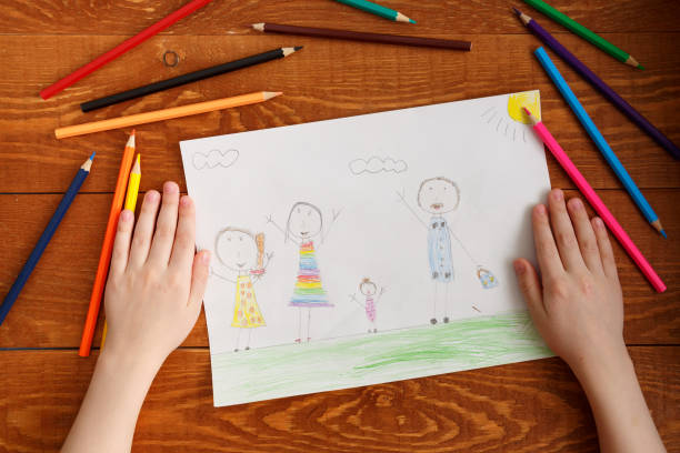 istock Character Child Hands and Image on Wooden Table 1187955028