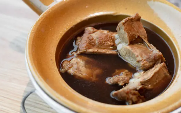 Photo of Bak kut teh, Baby pork ribs stewed in boiled water, herbs and spices. Chinese curry that is popular in Malaysia, Singapore, China, Taiwan.