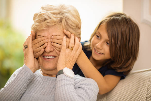 istock Playful boy covers his grandmother eyes 1187958683
