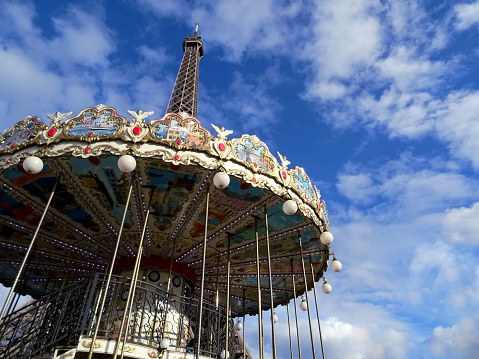 Paris France - April 4, 2019: XVIII century carousel horses behind in the background the magnificent  eiffel Tower