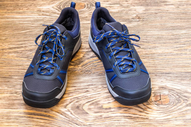 istock black outdoor sneakers on wooden surface 1187964679