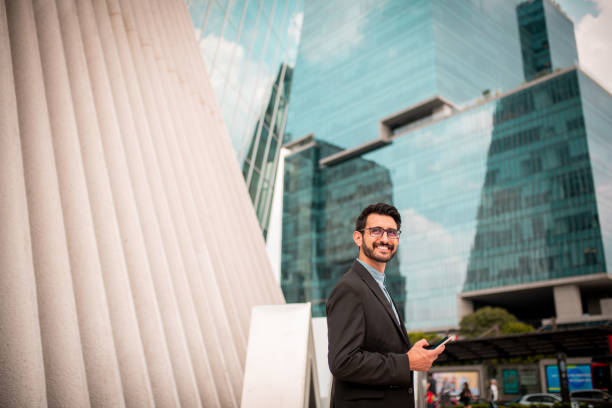 istock Smiling businessman using the mobile phone 1187965396