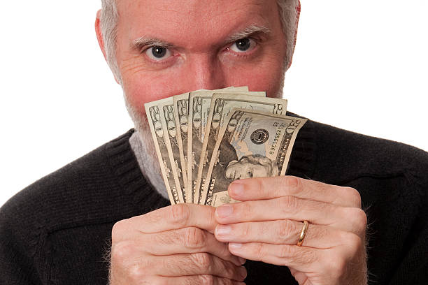 istock Man Holding Fan of Twenty Dollar Bills 118796802