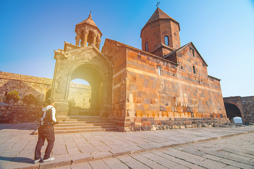 Asian traveler woman hand hold camera standing at The Khor Virap,Armenia monastery.