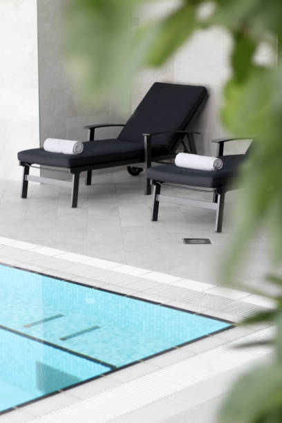 istock Chairs with towels next to the pool 1187969109
