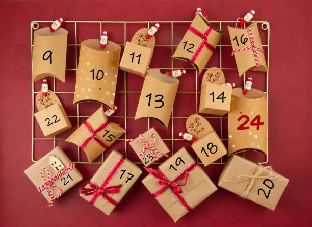 Photo of Advent calendar with craft carton boxes on the mesh board