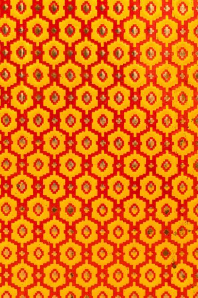 Metallic texture of red and yellow hexagons. Pattern. Retro look, old and shiny.